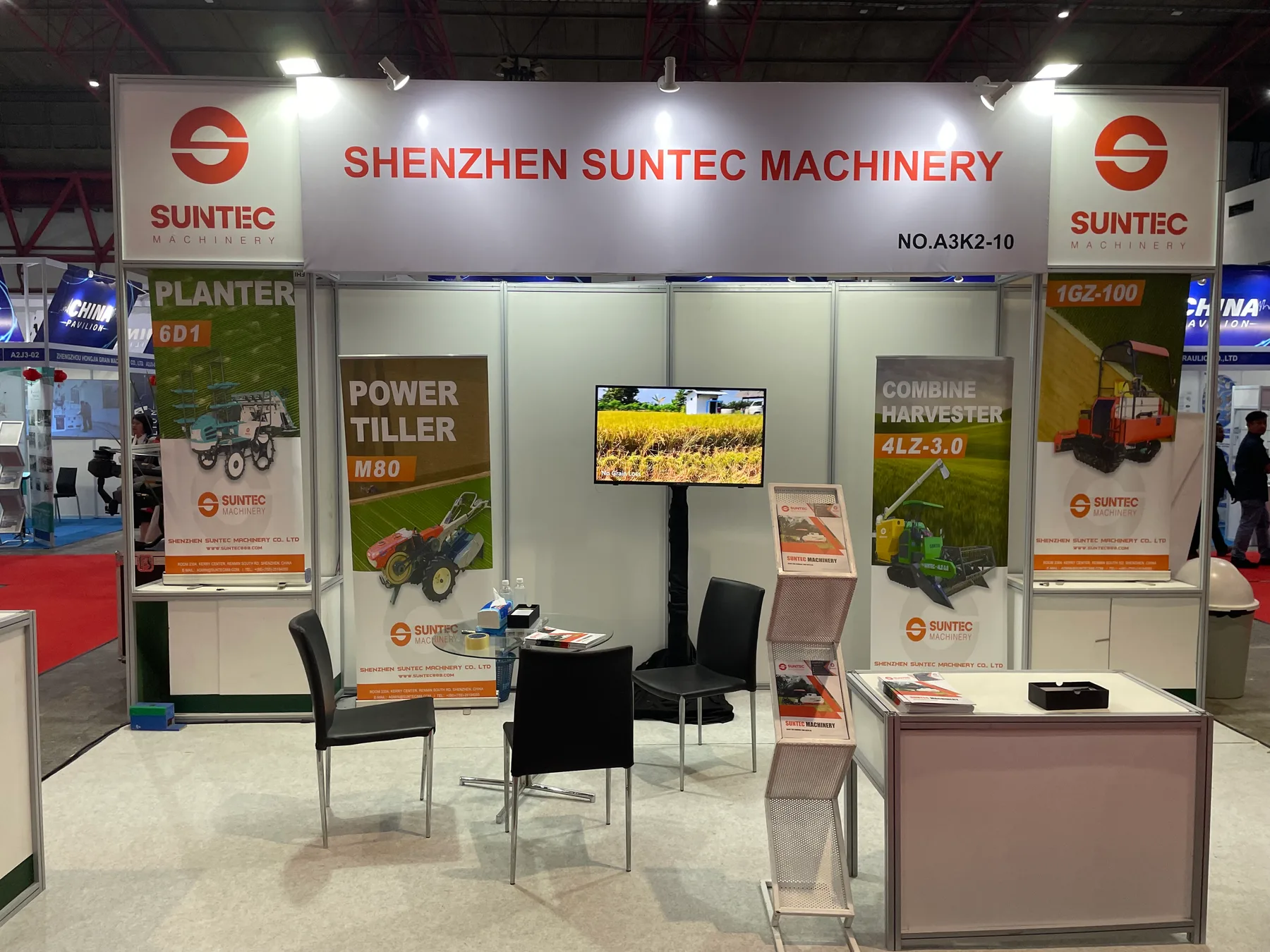 SUNTEC exhibition booth with the Shenzhen SUNTEC Machinery name and product displays visible