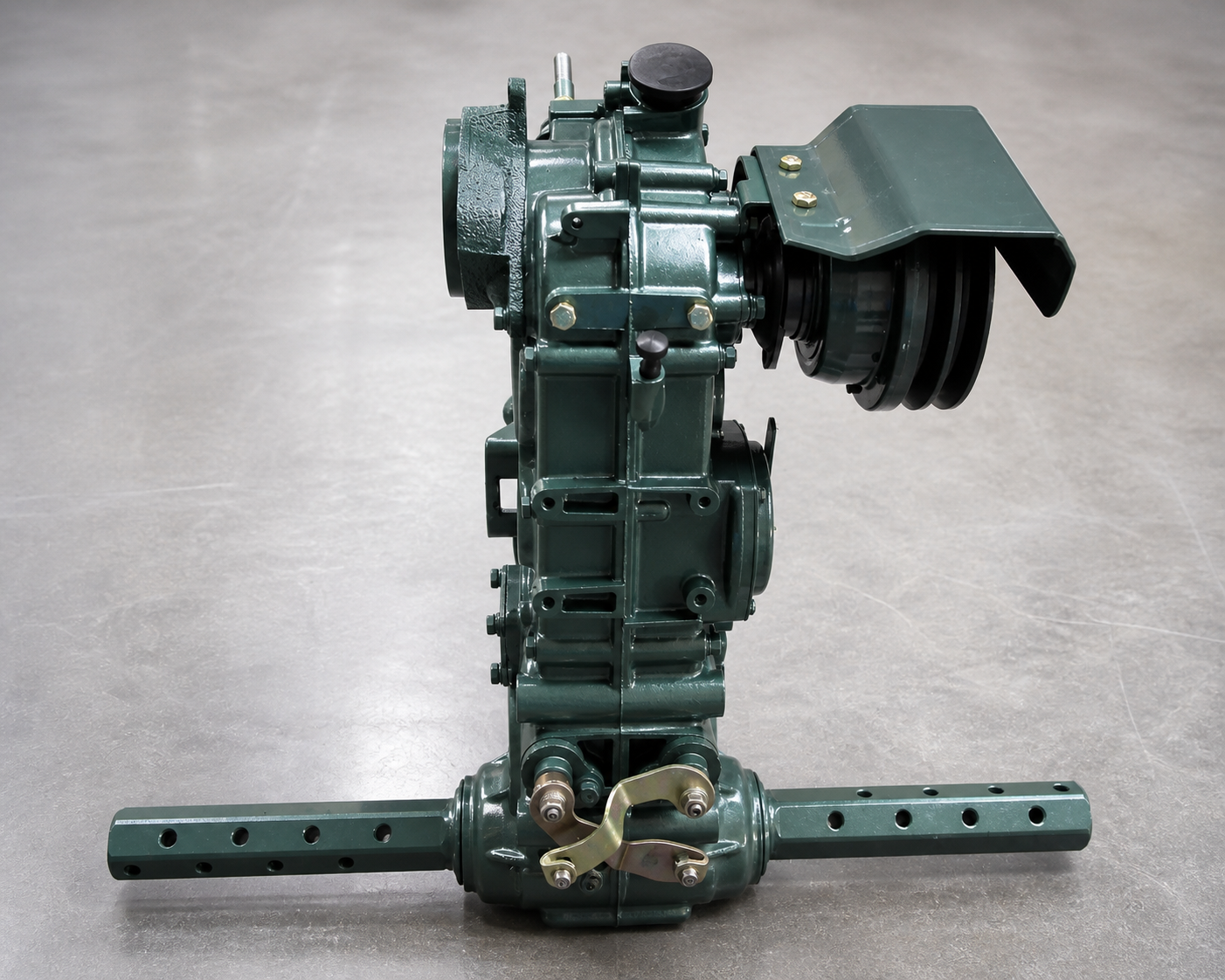 Complete dark-green walking-tractor gearbox and axle assembly on an inspection table